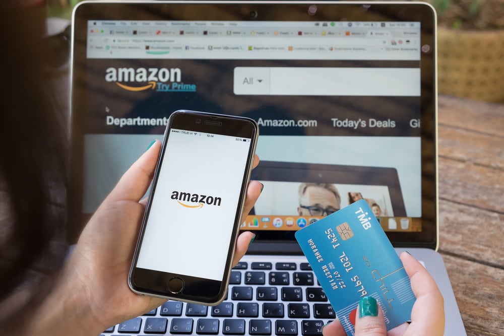 iPhone 6s showing Amazon logo and credit card shopping online. Amazon.com, Inc. American international electronic commerce company